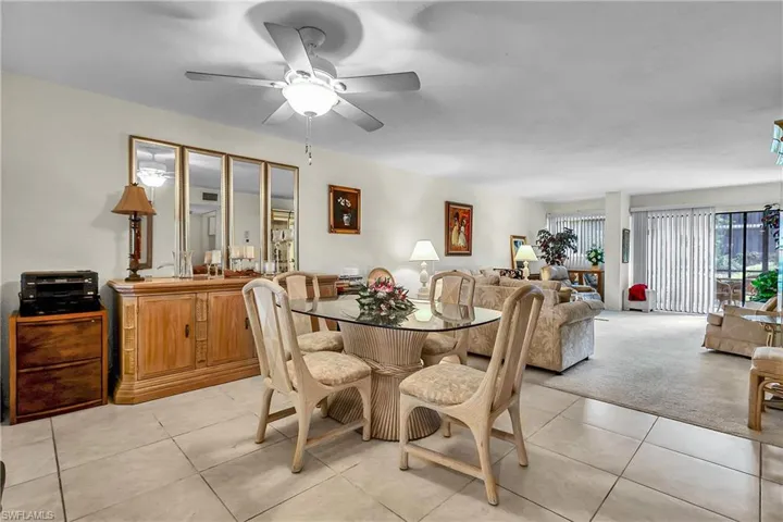 Dining area featuring light tile patterned floors and a ceiling fan
