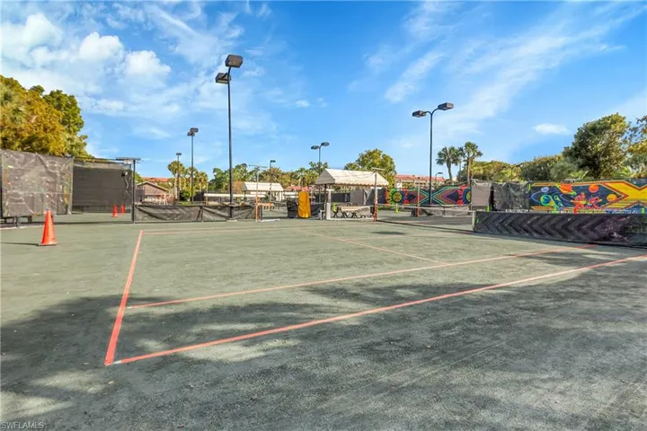 View of community with a tennis court
