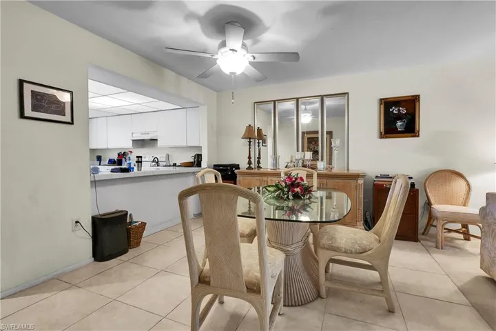 Dining room featuring light tile patterned floors and a ceiling fan