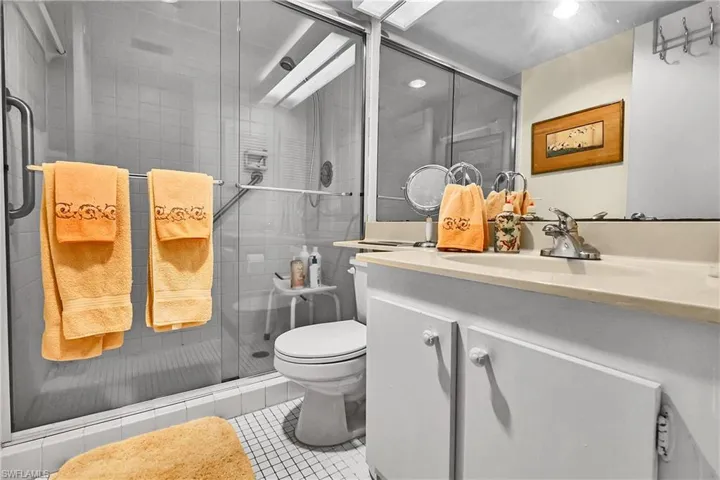 Bathroom with vanity, light tile patterned floors, a stall shower, and recessed lighting