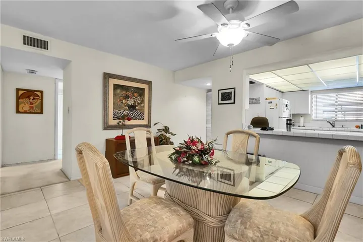 Dining space with light tile patterned floors and ceiling fan
