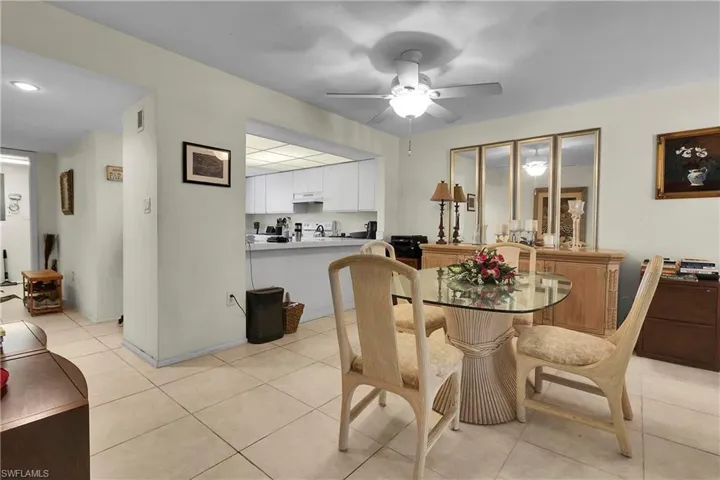 Dining area with light tile patterned floors and ceiling fan