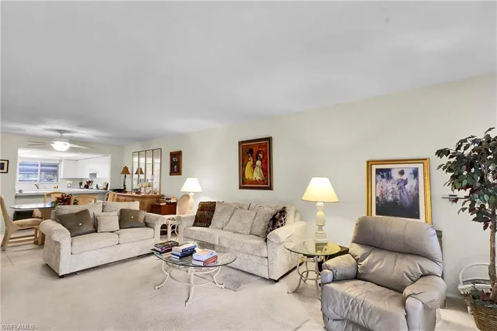 Living area with carpet flooring and a ceiling fan