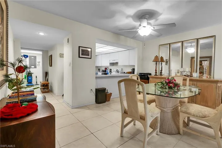 Dining space with light tile patterned floors and ceiling fan