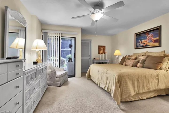 Bedroom featuring access to exterior, light carpet, and ceiling fan