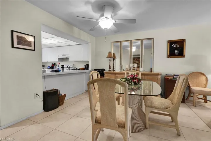Dining space featuring light tile patterned flooring and ceiling fan