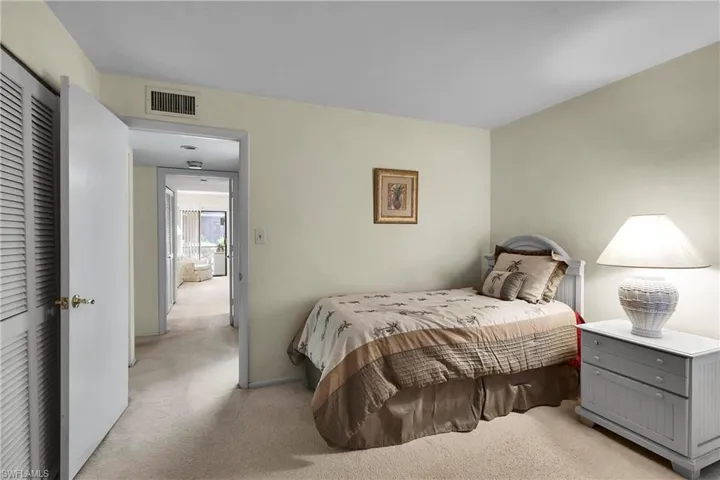 Bedroom featuring light colored carpet
