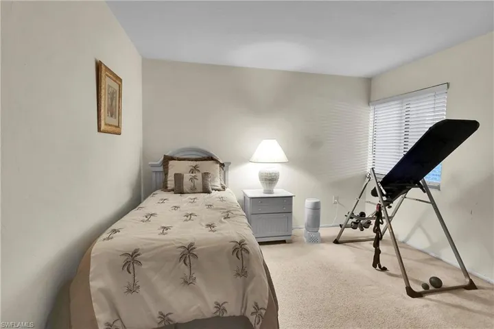 Bedroom featuring light colored carpet