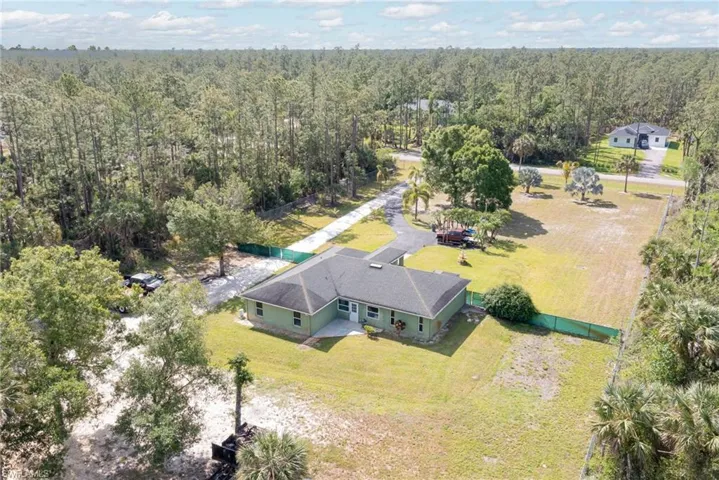 View from above of property featuring a heavily wooded area