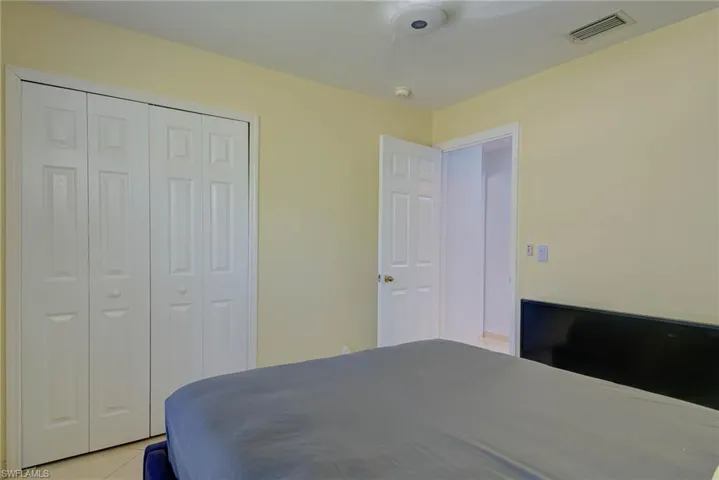 Bedroom featuring a closet and light tile patterned floors