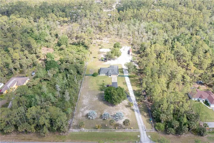Aerial view of property's location featuring a forest