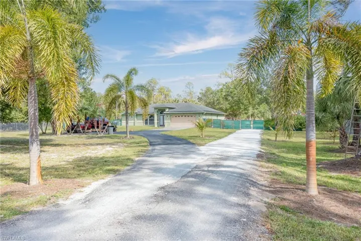 View of front of house with driveway and an attached garage