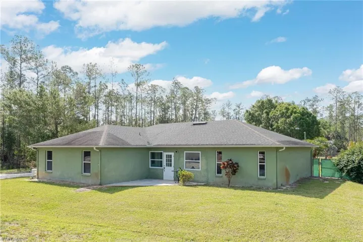 Rear view of property featuring stucco siding and a patio area