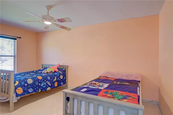 Bedroom featuring tile patterned floors and a ceiling fan