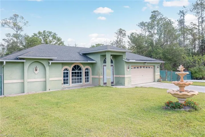 Ranch-style home with stucco siding, an attached garage, concrete driveway, and a shingled roof