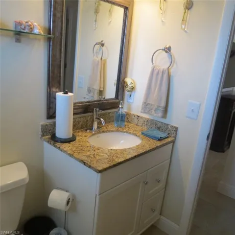 Bathroom with vanity, tile patterned flooring, and toilet
