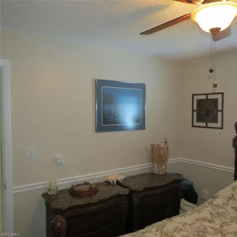 Bedroom featuring a textured ceiling and ceiling fan