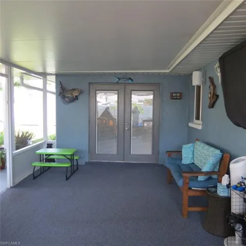 Sunroom / solarium featuring a wealth of natural light and french doors