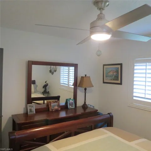 Bedroom featuring multiple windows and ceiling fan
