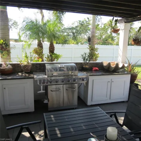 View of patio / terrace featuring a wooden deck and area for grilling