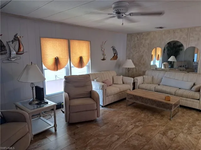 Living room with tile floors and ceiling fan