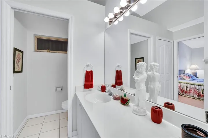 Bathroom featuring vanity, toilet, and tile patterned flooring