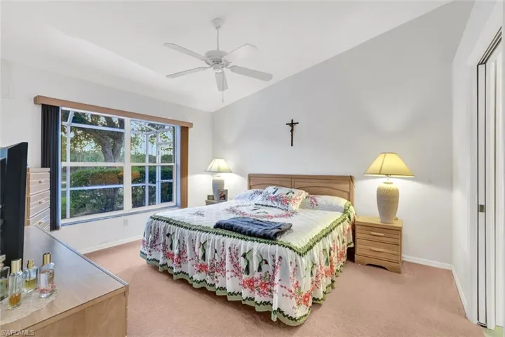 Carpeted bedroom with ceiling fan