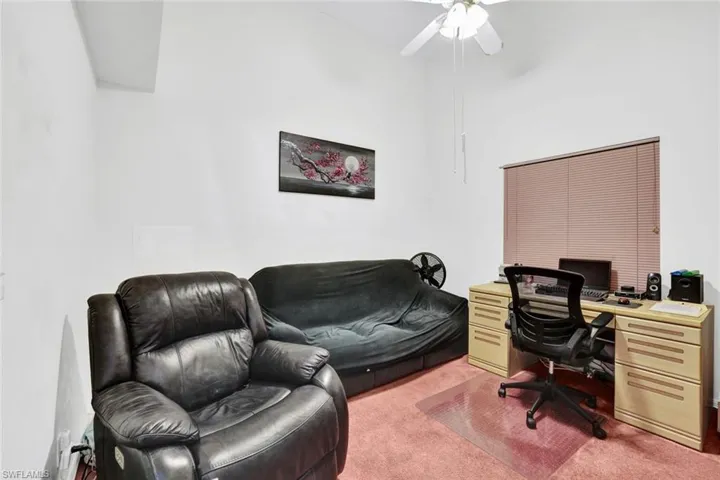Carpeted office with ceiling fan