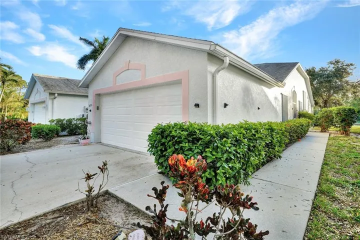 View of property exterior featuring a garage