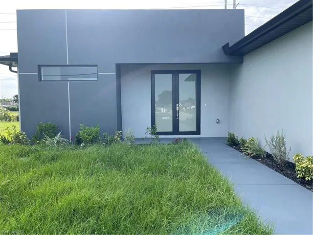 Entrance to property featuring french doors and stucco siding
