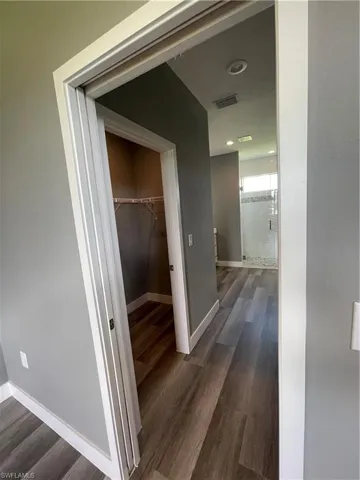Corridor with dark wood-style flooring