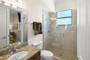 Guest bathroom has a large walk-in tiled shower with custom glass enclosure has a second entrance.