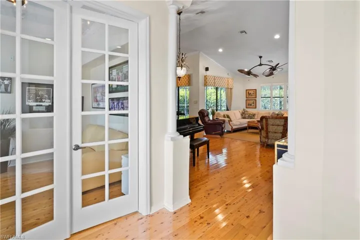 Corridor featuring vaulted ceiling, wood finished floors, and recessed lighting