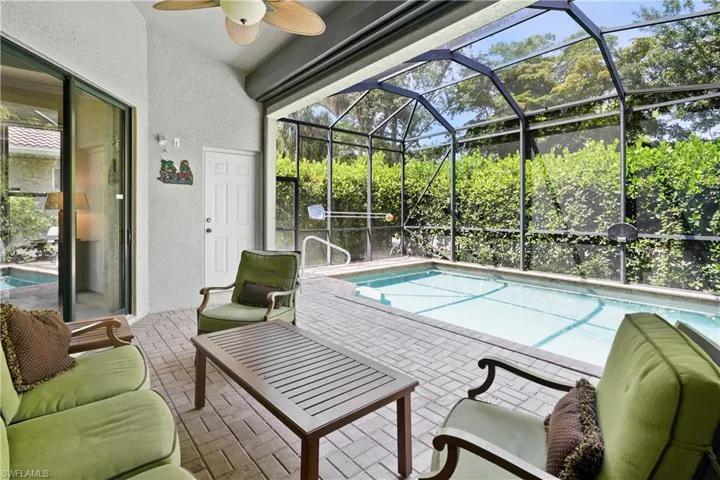Outdoor pool featuring a patio area, a lanai, and ceiling fan
