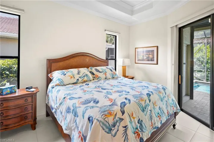 Tiled bedroom with access to exterior and ornamental molding
