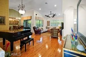 Entering the home from the front foyer, you enter the great room. You will feel the elegance of a professionally decorated home! Beautiful chandeliers, double palm paddle fans, bamboo flooring, custom window coverings.  The Player Baby Grand is for sale seperatly.