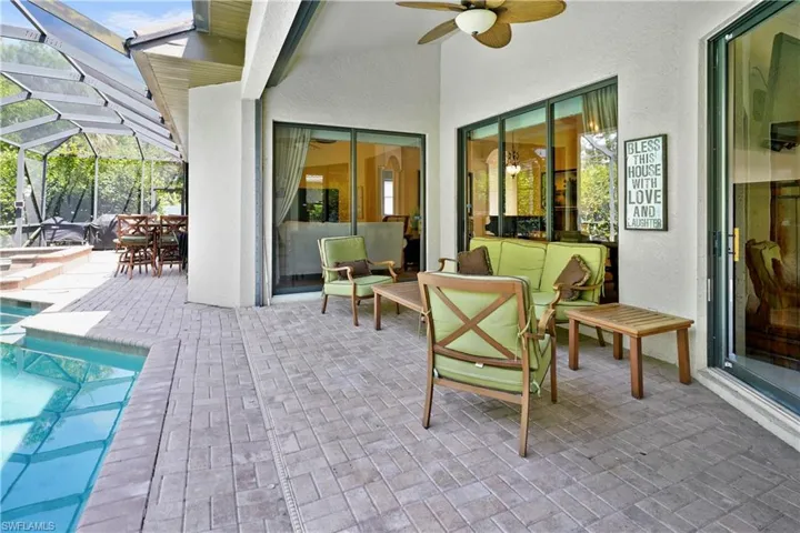 View of patio featuring a ceiling fan, an outdoor pool, and a lanai