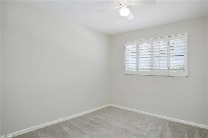 Guest bedroom with plantation shutters