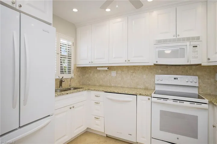 Great white kitchen with granite counters