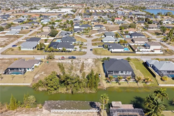 View of property location featuring a large body of water and nearby suburban area