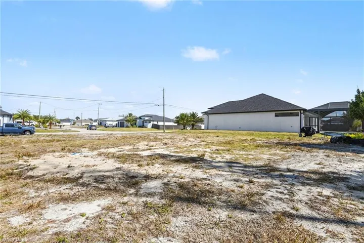 View of yard featuring a residential view and glass enclosure