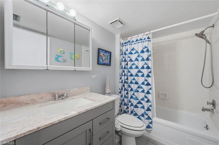 Bathroom featuring shower / bath combo and vanity