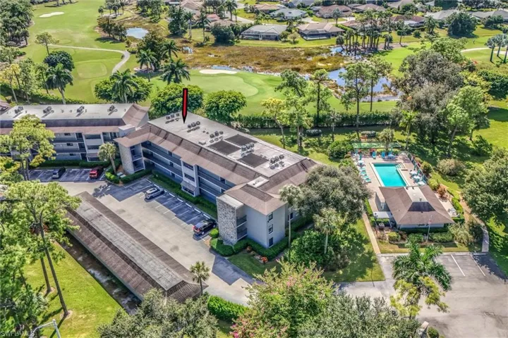 Drone / aerial view of a nearby body of water and a local golf course