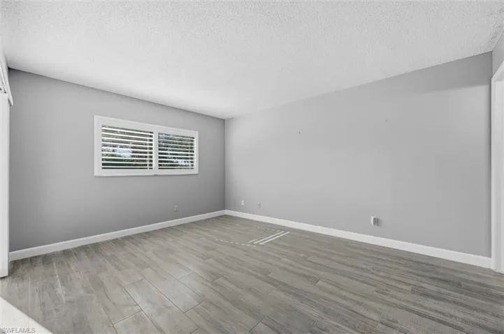Spare room featuring a textured ceiling and light wood-style flooring