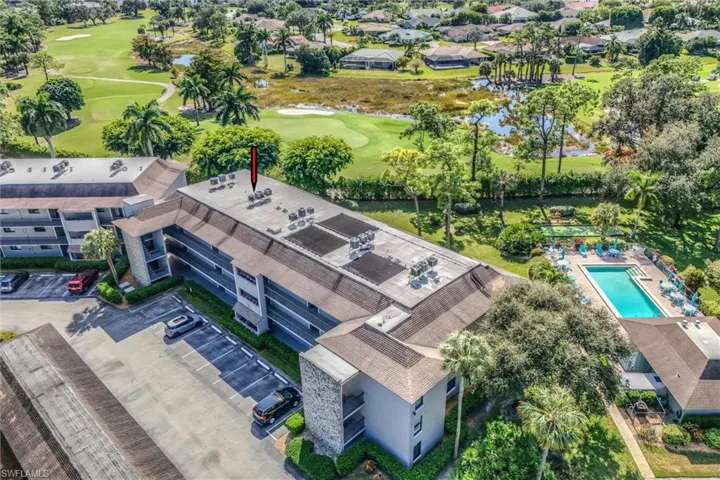 Drone / aerial view of a local golf course and a large body of water