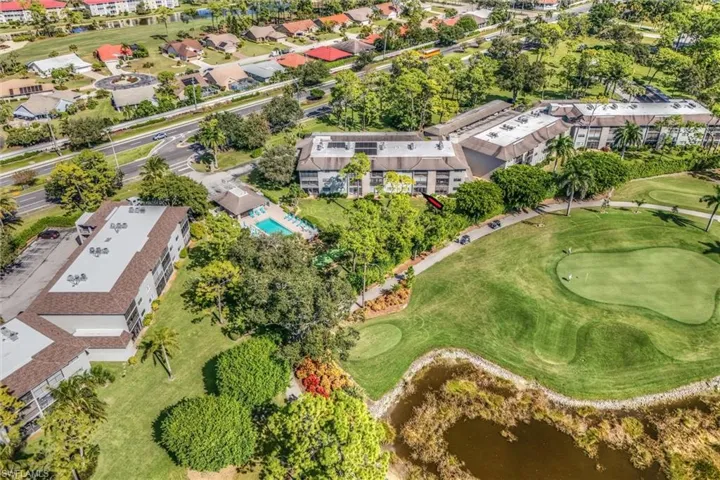 Aerial view of property's location featuring a nearby body of water and a golf club