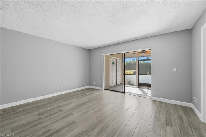 Spare room featuring a textured ceiling, light wood finished floors, and a ceiling fan