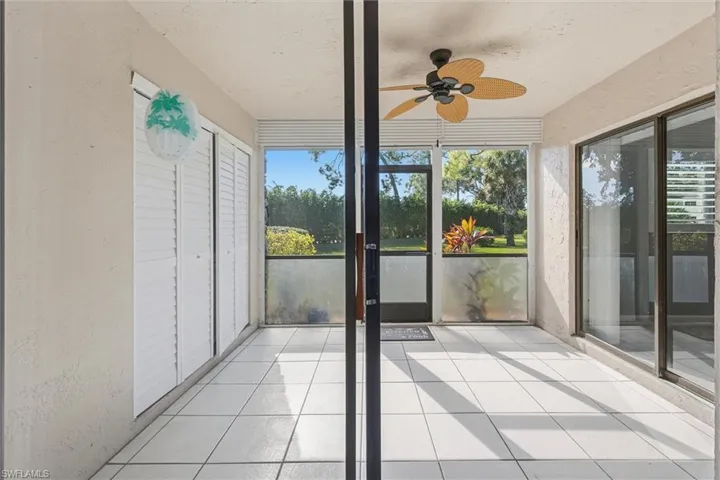 Unfurnished sunroom featuring ceiling fan and healthy amount of natural light