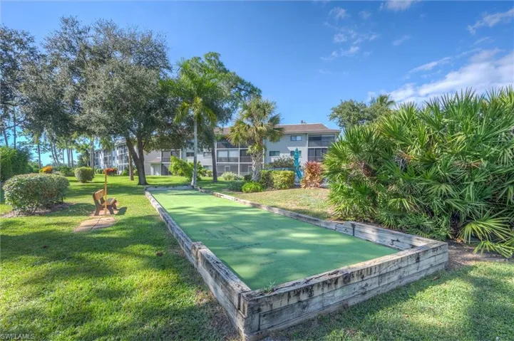 Surrounding community with a game area and a yard