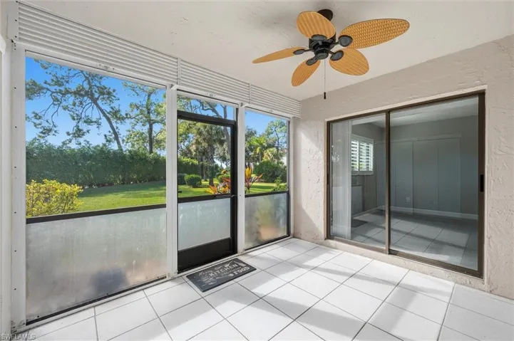 Unfurnished sunroom with a ceiling fan